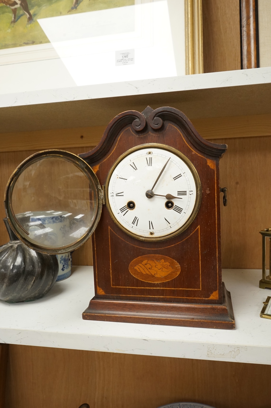 An early 20th century inlaid mantel clock with key and pendulum and a brass cased carriage timepiece, largest 32cm high